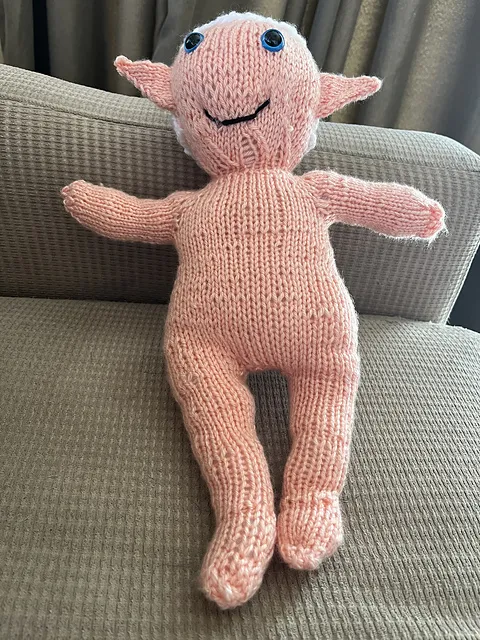 A knit doll of Alphinaud. HE'S NAKED! His hair cap has been sewn on but the strands of hair not placed yet. NAKED ALPHINAUD!!