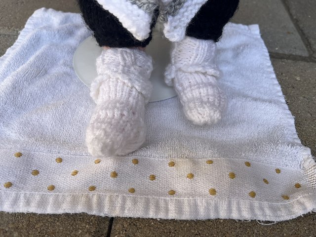 A close-up view of a knitted doll of Alphinaud from Final Fantasy XIV, showing off his white knee-high boots. Alphinaud, Boots