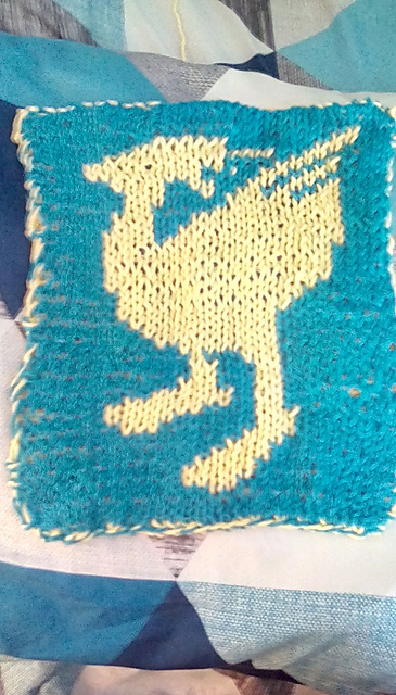 A double knit hotpad featuring a chocobo. This is the front view, showing a yellow chocobo on a teal background. Chocobo Hotpad, front